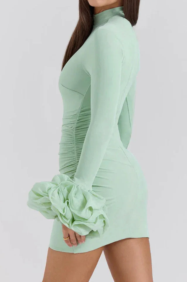 Mint green bodycon mini dress with long sleeves and ruffled cuffs, back-side view