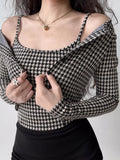 Close-up of a woman wearing a houndstooth print camisole with a cardigan draped off the shoulders.