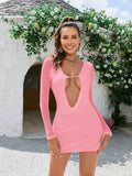 Woman wearing a pink mesh mini dress with a draped collar and long sleeves