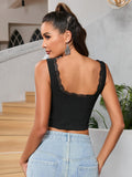 Back view of a woman in a black sleeveless cropped top with lace trim detail on the neckline.