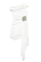 White one-shoulder asymmetrical mini dress with ruched detailing, draped chiffon overlay, and a floral embellishment, shown flat.