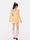 Back view of a woman in a yellow tie-dye mini dress.