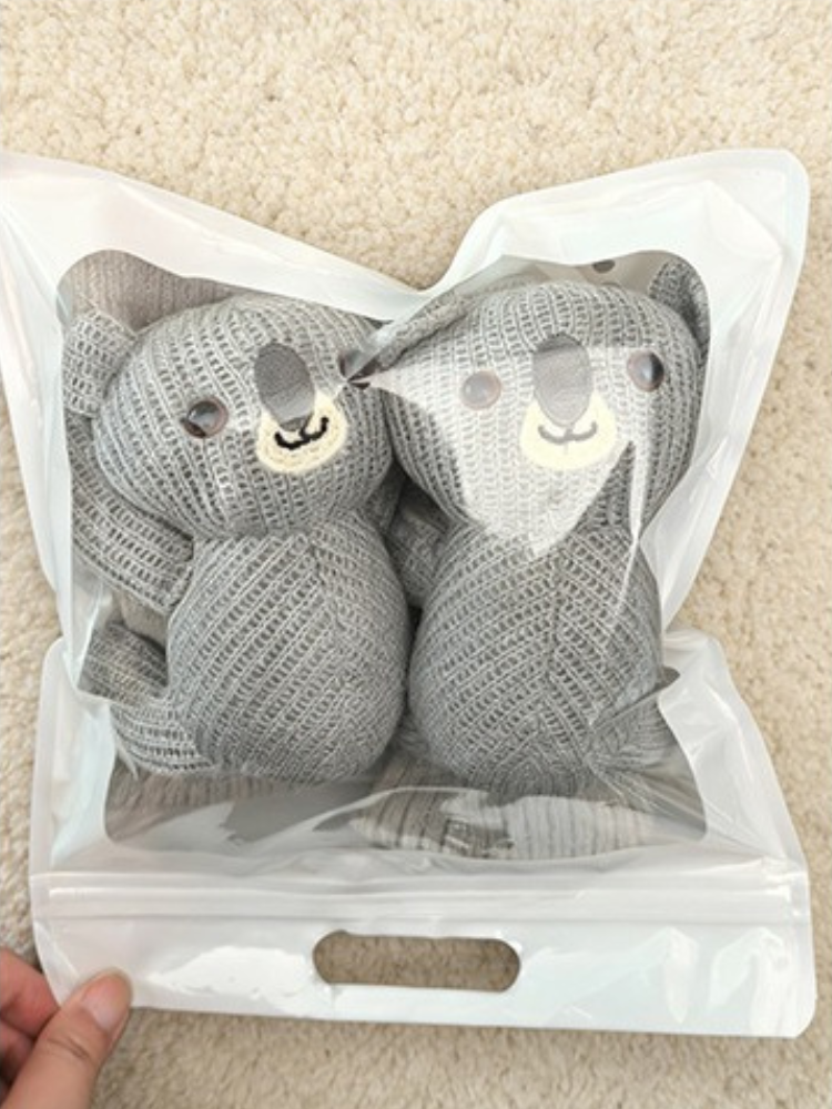 Two gray knit ankle socks with 3D koala appliques, packaged in a clear plastic bag.