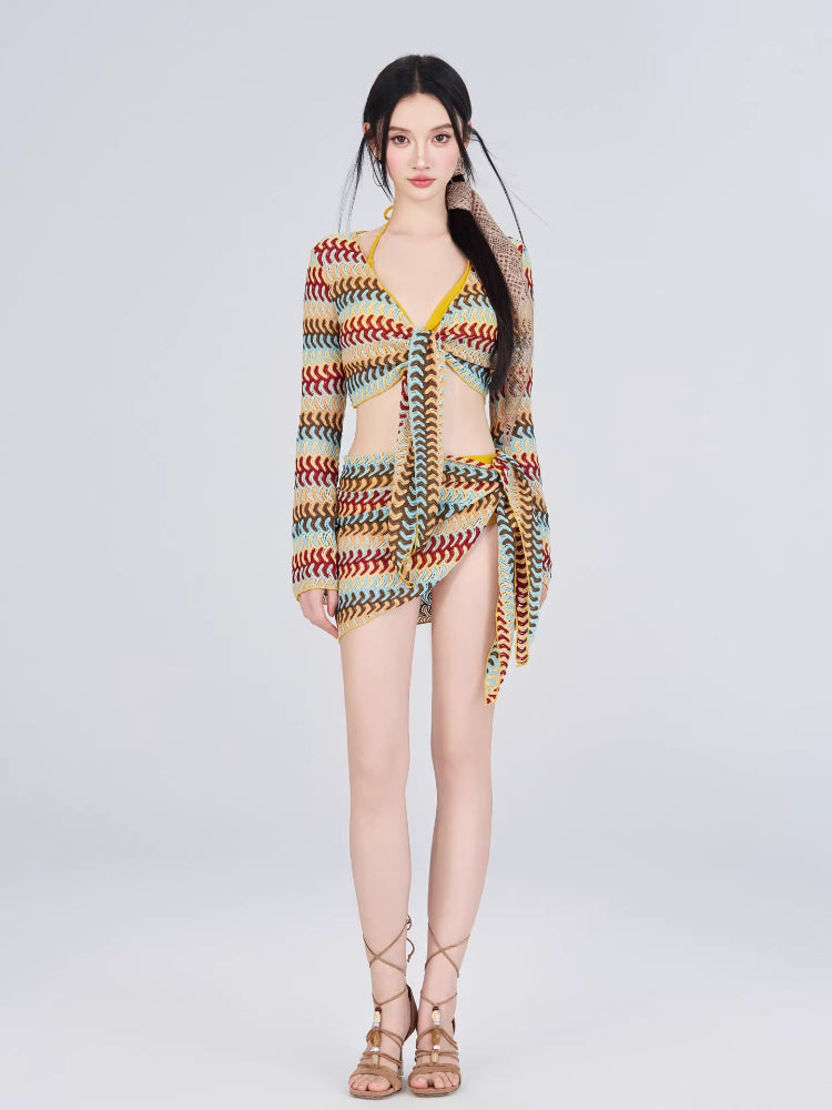 Full body shot of a woman in a crochet knit set with a wrap skirt