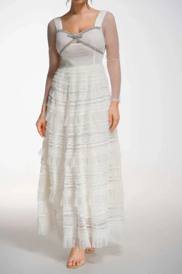 Front view of a white formal gown with a sweetheart neckline and ruffled skirt