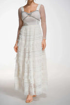 Front view of a white formal gown with a sweetheart neckline and ruffled skirt
