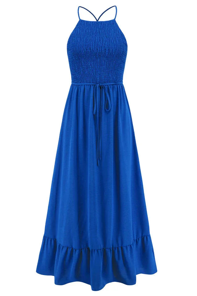 Studio shot of a royal blue smocked halter maxi dress with a tiered ruffle hem and drawstring waist.
