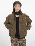 Woman showing the front of a brown crushed velvet bomber jacket