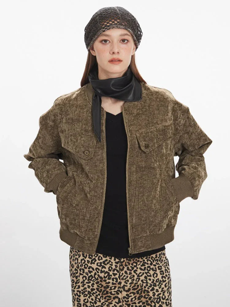 Woman showing the front of a brown crushed velvet bomber jacket