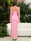 Back view of a pink long sleeve halter neck maxi dress with tie detail