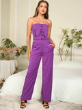 Fashionable woman in a purple wide-leg pant set with a strapless top