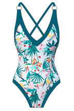 Front view product image of a white one-piece swimsuit with a tropical floral print and teal trim