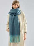 Full body shot of a woman modeling a teal scarf