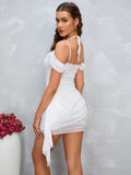 Woman from behind wearing a red sleeveless dress with an open back featuring a tie closure.