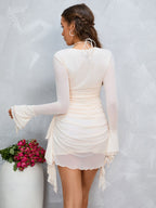 Back view of a cream ruched bodycon dress with lace-up neckline and flared sleeves