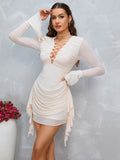 Front view of a woman in a cream ruched bodycon dress with lace-up detail