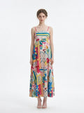 Woman wearing a colorful patchwork print maxi dress with spaghetti straps