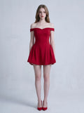 Woman wearing a red off-the-shoulder fit and flare dress