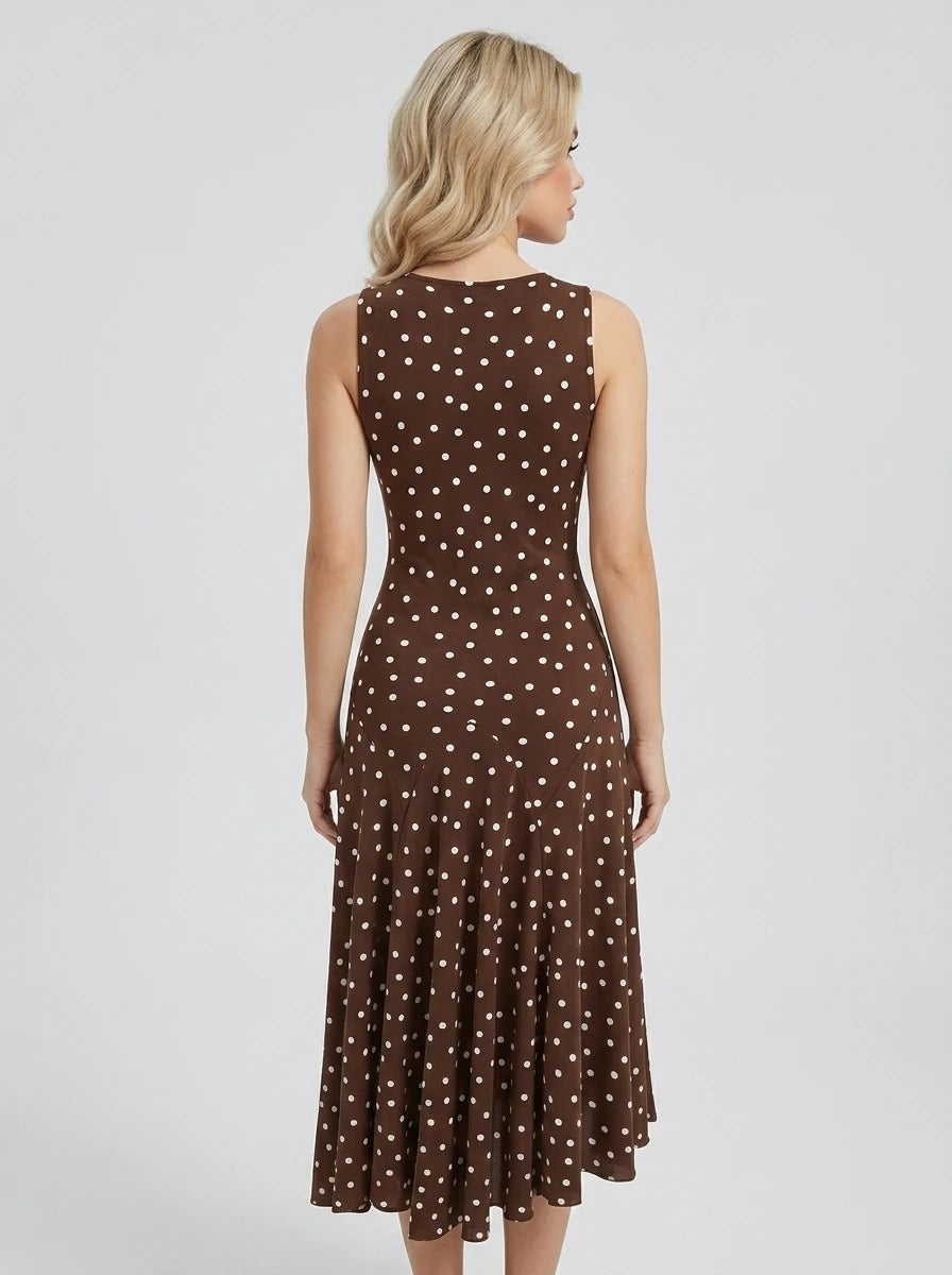 Back view of a woman in a brown polka dot sleeveless midi dress
