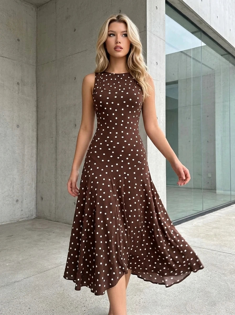 Woman walking outdoors wearing a brown polka dot sleeveless midi dress
