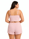 Back view of a plus-size woman in a pink ribbed knit pajama set
