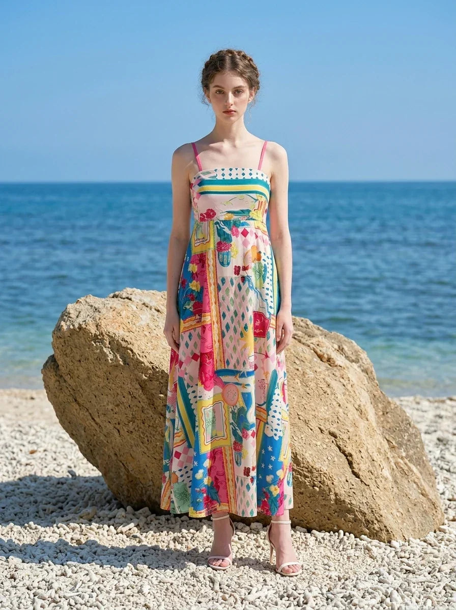 Woman in a vibrant patchwork print maxi dress with the ocean in the background