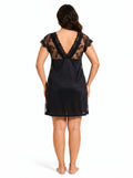 Woman wearing a black lace-trimmed chemise from the back.