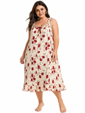 Full body shot of a woman in a cream and red floral print nightgown.