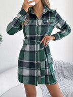 Close-up of the green plaid flannel shirt dress, highlighting the tie waist and collar.