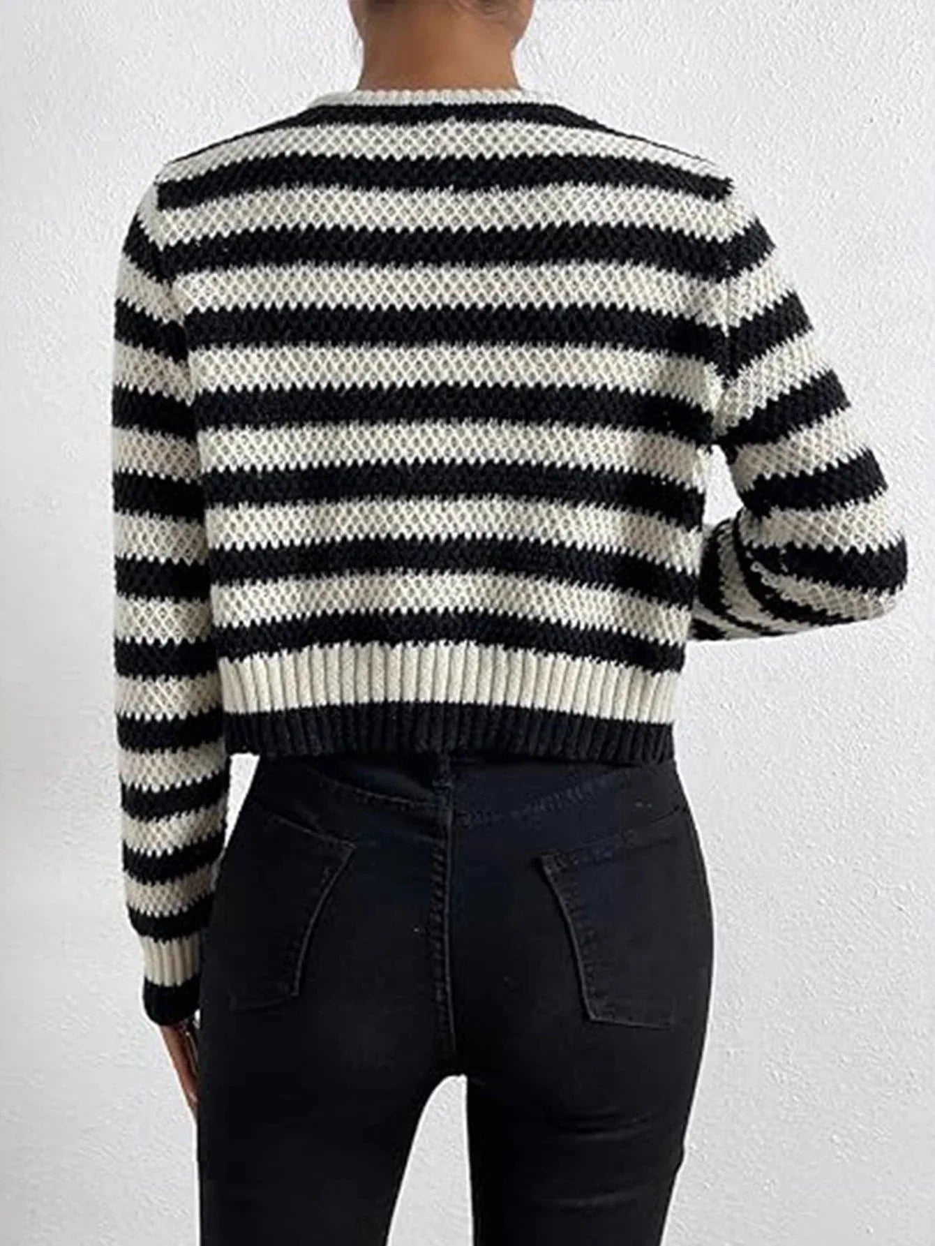 Back view of a black and white striped knit cardigan