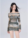 Woman in a sheer mesh off-the-shoulder top and mini skirt with the word 'PRINCESS' visible on the skirt.