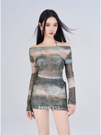 Woman in a sheer mesh off-the-shoulder top and mini skirt with the word 'PRINCESS' visible on the skirt.