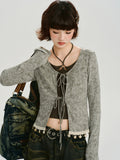 Close-up of the grey ribbed knit tie-front cardigan with lace trim