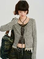 Close-up of the grey ribbed knit tie-front cardigan with lace trim