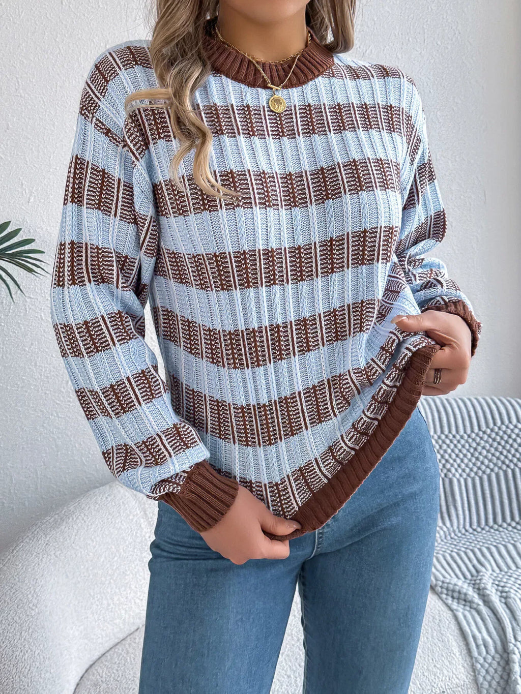 Woman wearing a blue and brown striped knit sweater