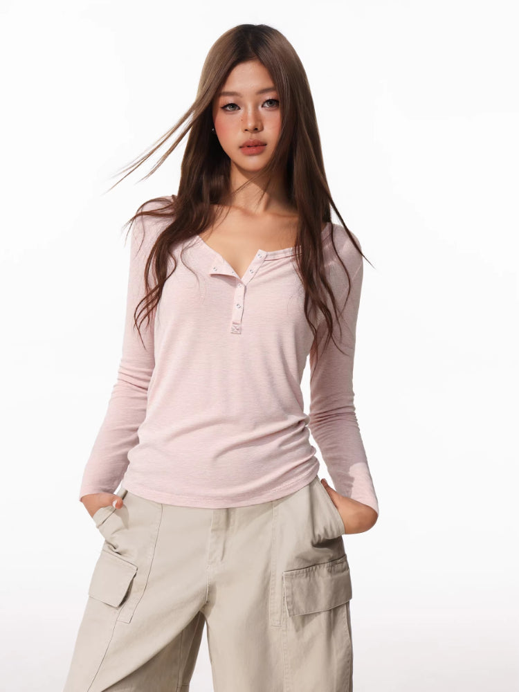 Woman wearing a pink long-sleeve henley shirt and beige cargo pants Main image