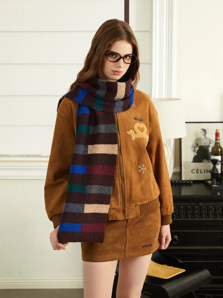 Woman wearing a brown bomber jacket and mini skirt with a colorful striped scarf