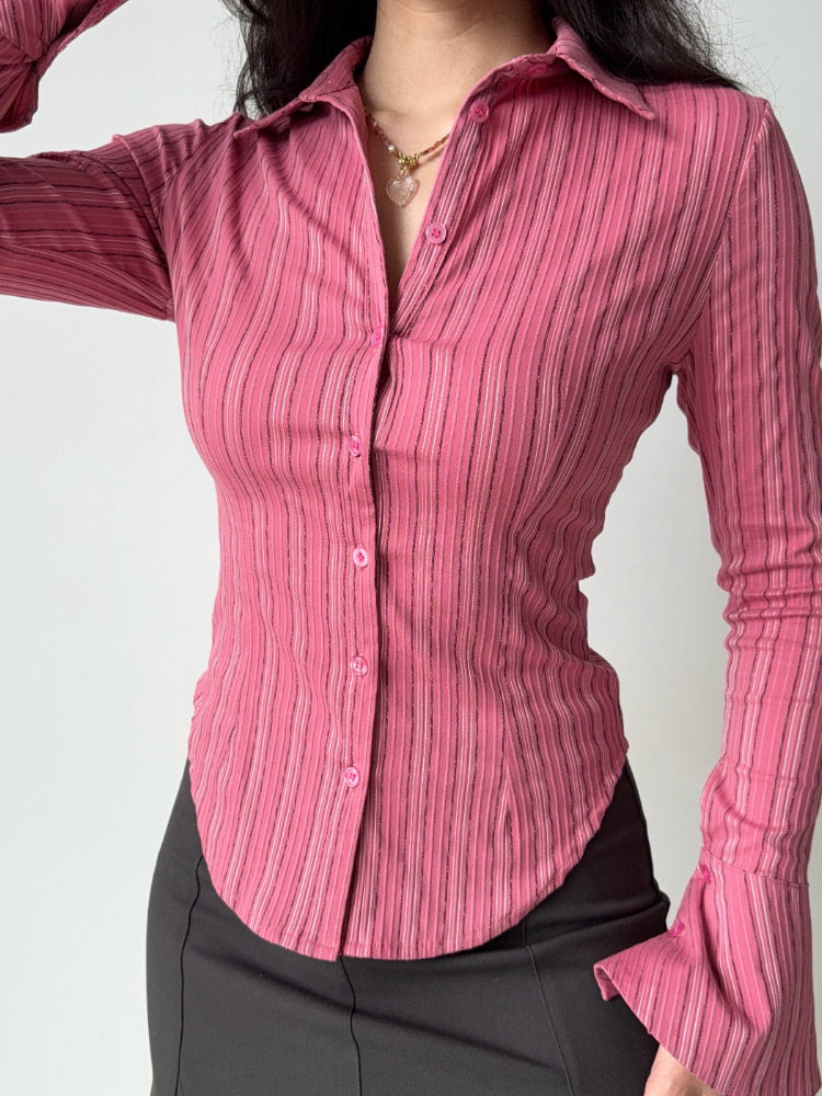 Close-up of a pink striped fitted shirt with button-down front.