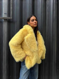Close-up of a woman in a yellow faux fur jacket
