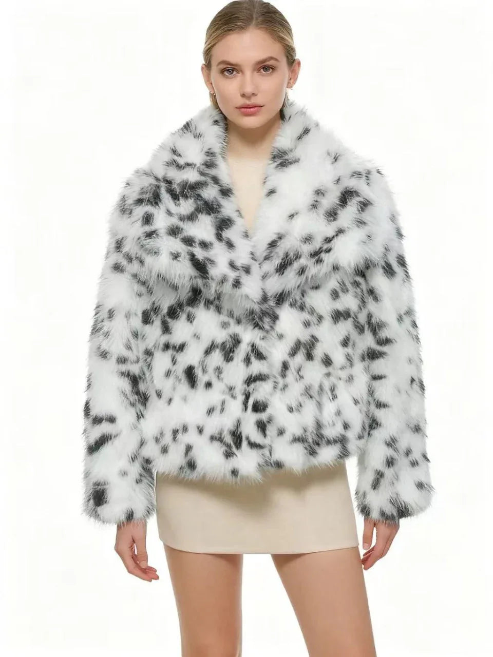Front view of a woman in a faux fur leopard print jacket, arms crossed
