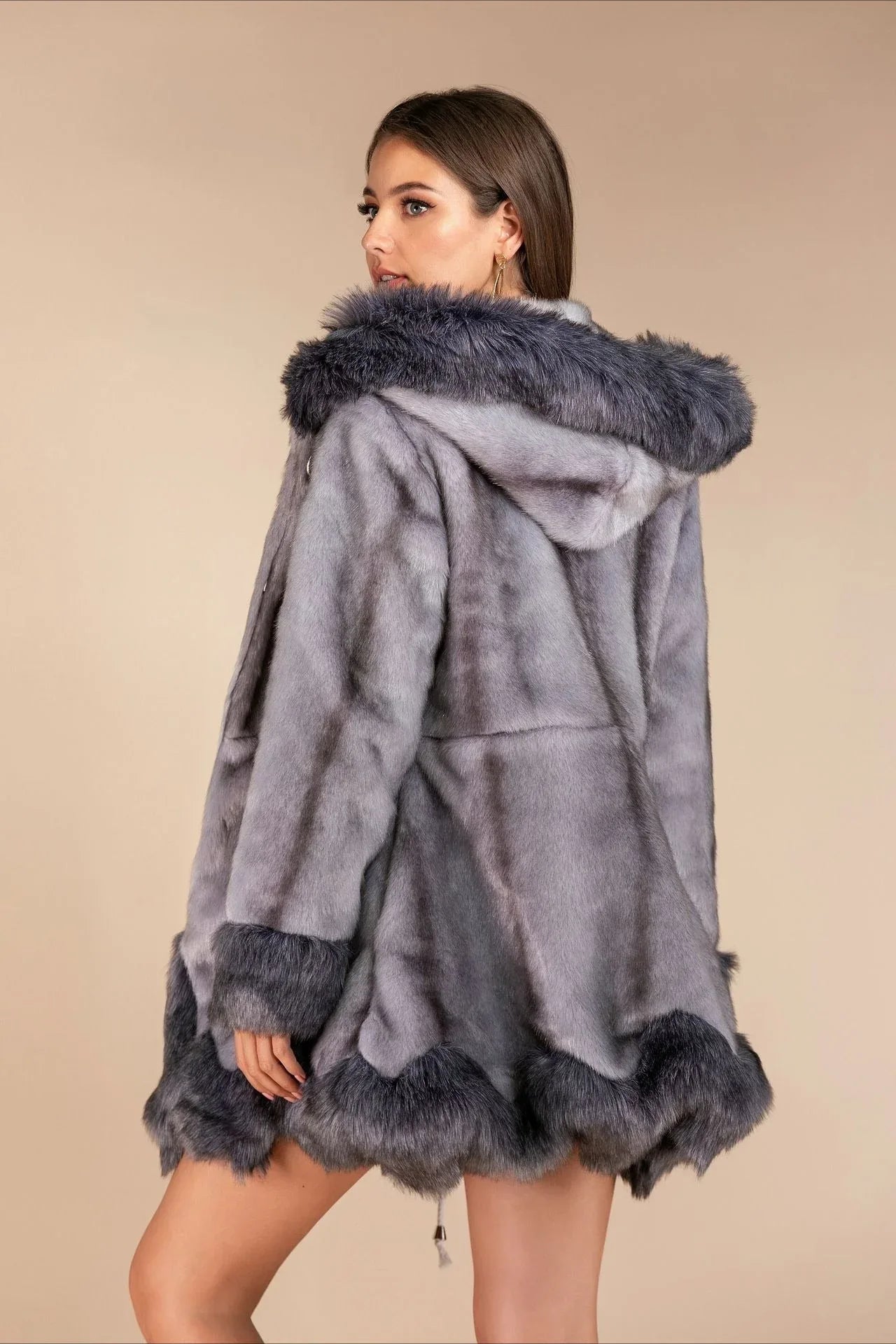 Rear view of a woman wearing a grey hooded faux fur coat
