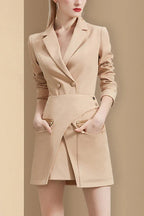 Front view of a tan blazer dress with zippered pockets
