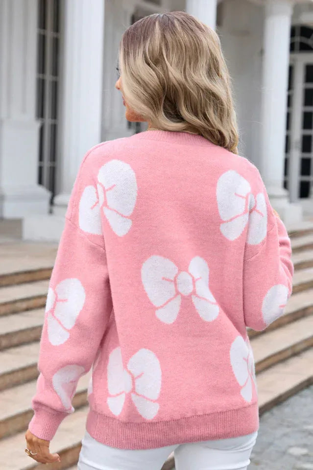 Back view of the pink knit sweater with white bow print.