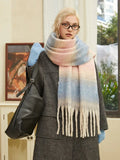 Woman posing with an oversized pastel scarf