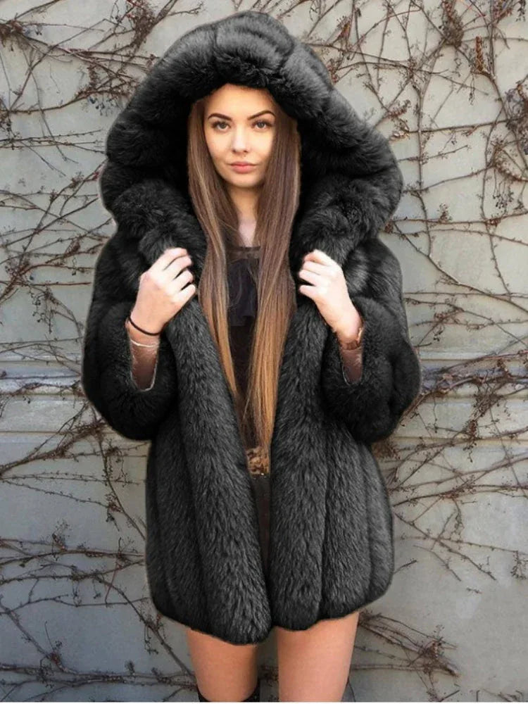 Woman wearing a black hooded faux fur coat.