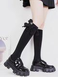 Styling example of black socks with loafers and a decorative bow.