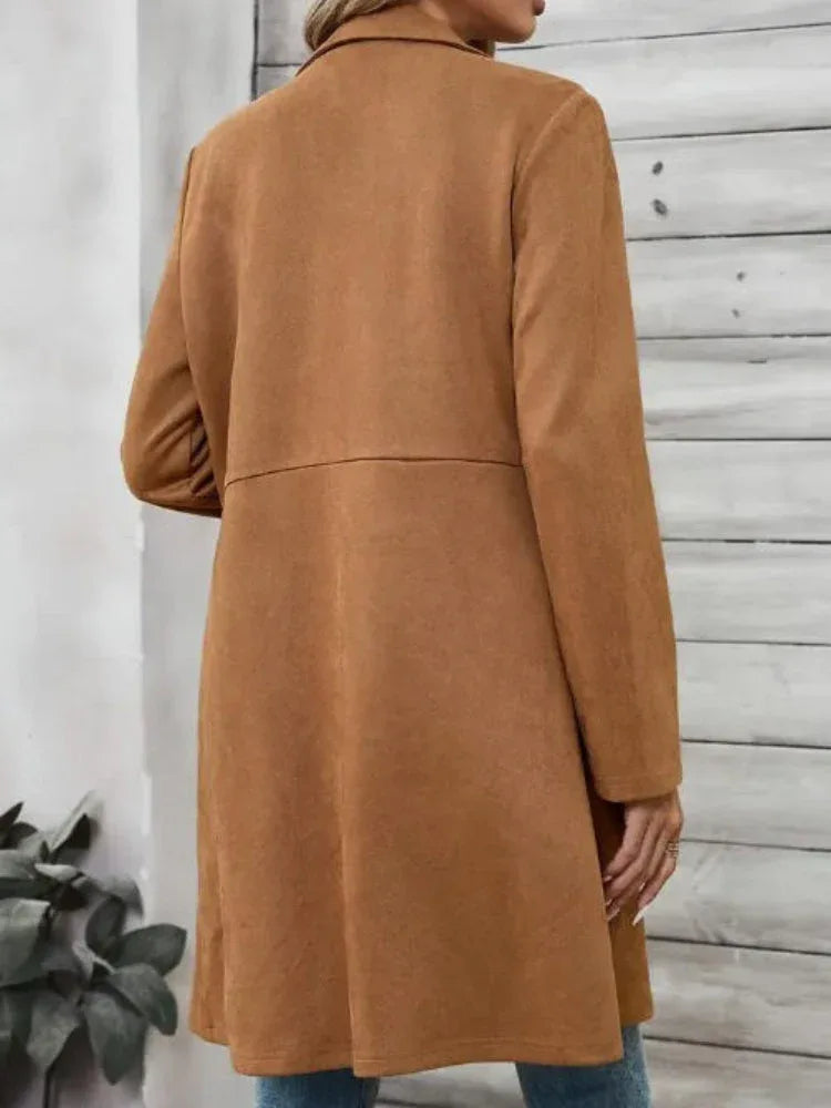 Back view of a woman wearing a brown suede-like longline coat.