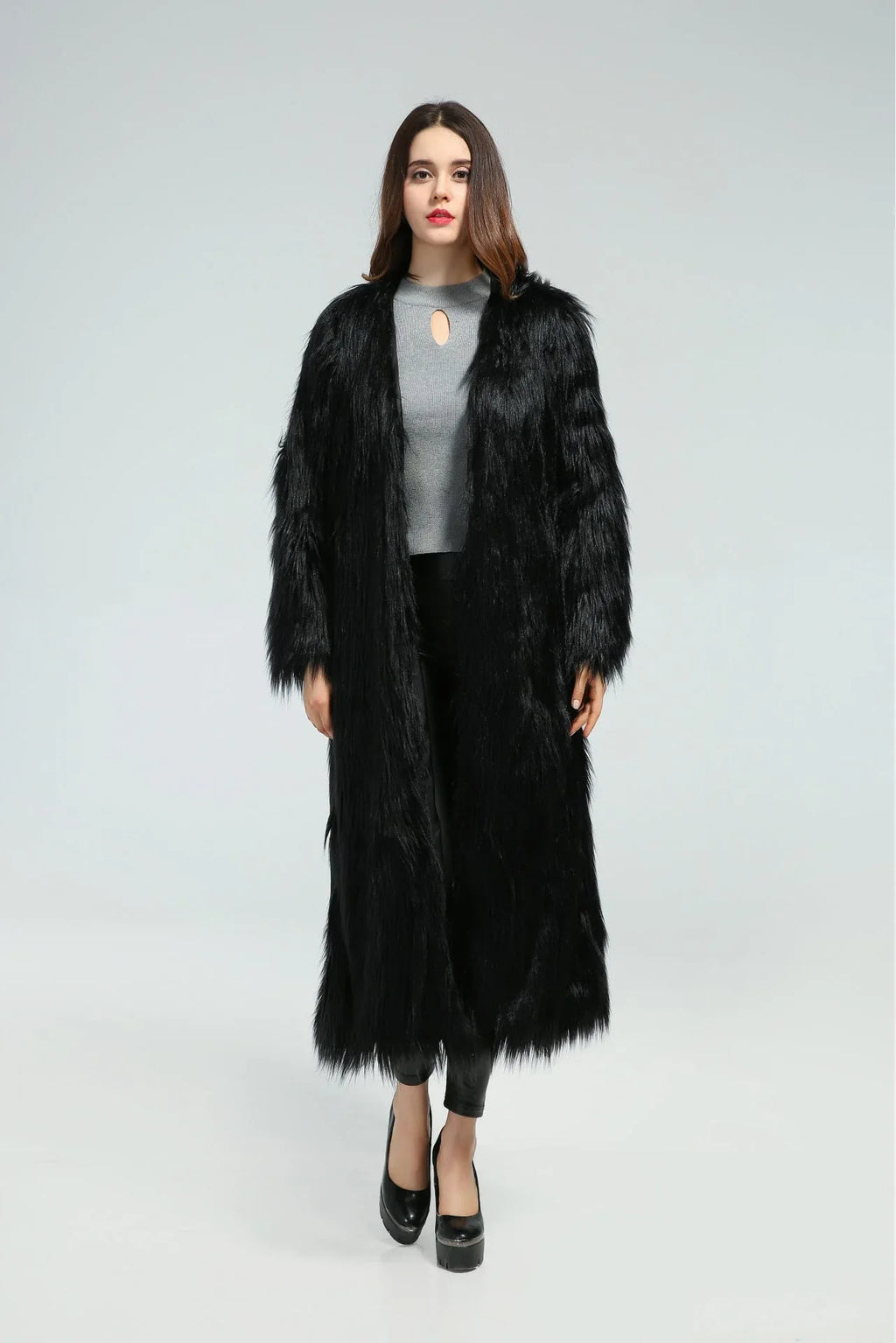 Front view of a woman modeling a black longline faux fur coat.