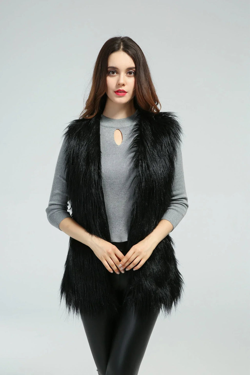 Woman in a black faux fur vest, front view