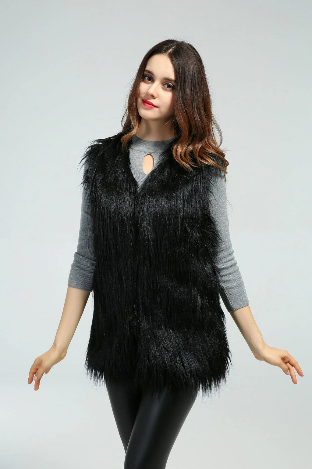 Woman in a black faux fur vest, front view with arms outstretched
